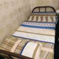 SAR 100,  This Appears To Be A Standard Single-size Metal Or Iron Frame Bed With A Patterned Mattres