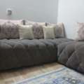 A Wooden Sofa Set Covered With Fabric